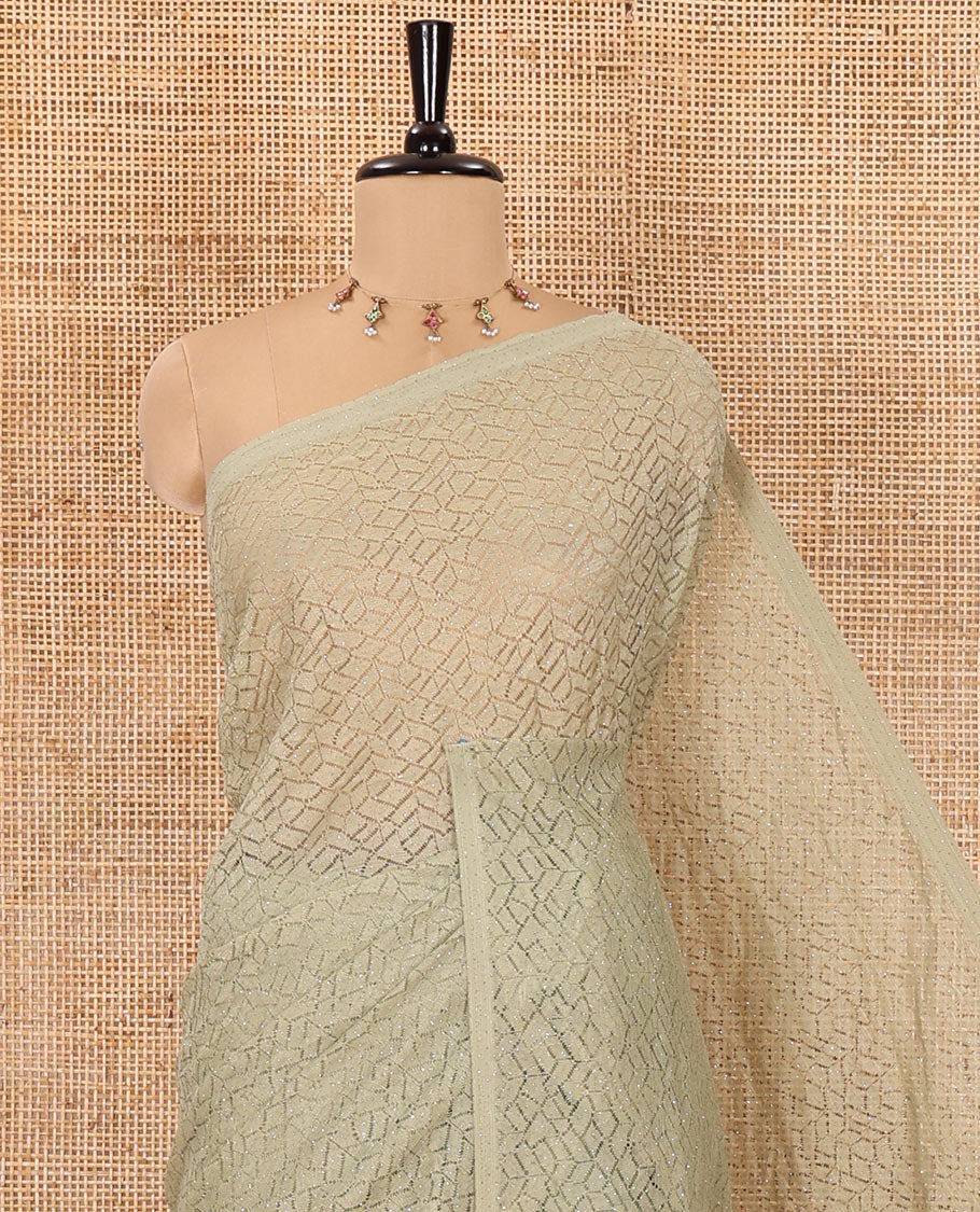 Borderless pista green sparkling glittered russel net saree, self-pallu and a floral print with zig-zag embroidered blouse