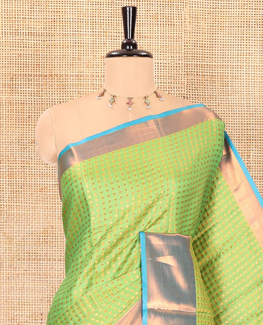 Parrot green zari buttas semi-soft silk saree, contrast plain zari border, contrast zari buttas steeped pallu, and a contrast zari design blouse