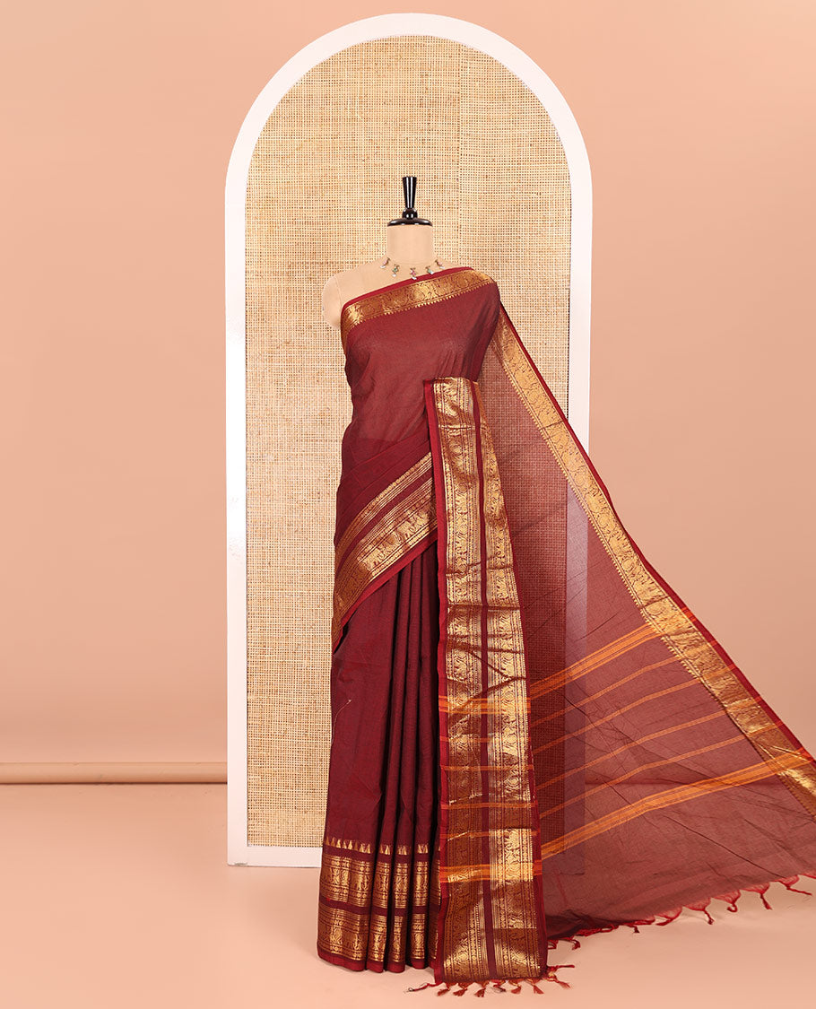 Maroon Plain Chettinad Cotton Saree Accentuated with a Gleaming Zari Rettai Pettu Border Featuring Elephant and Peacock Motifs, Subtly Striped Pallu, and Paired with a Matching Blouse