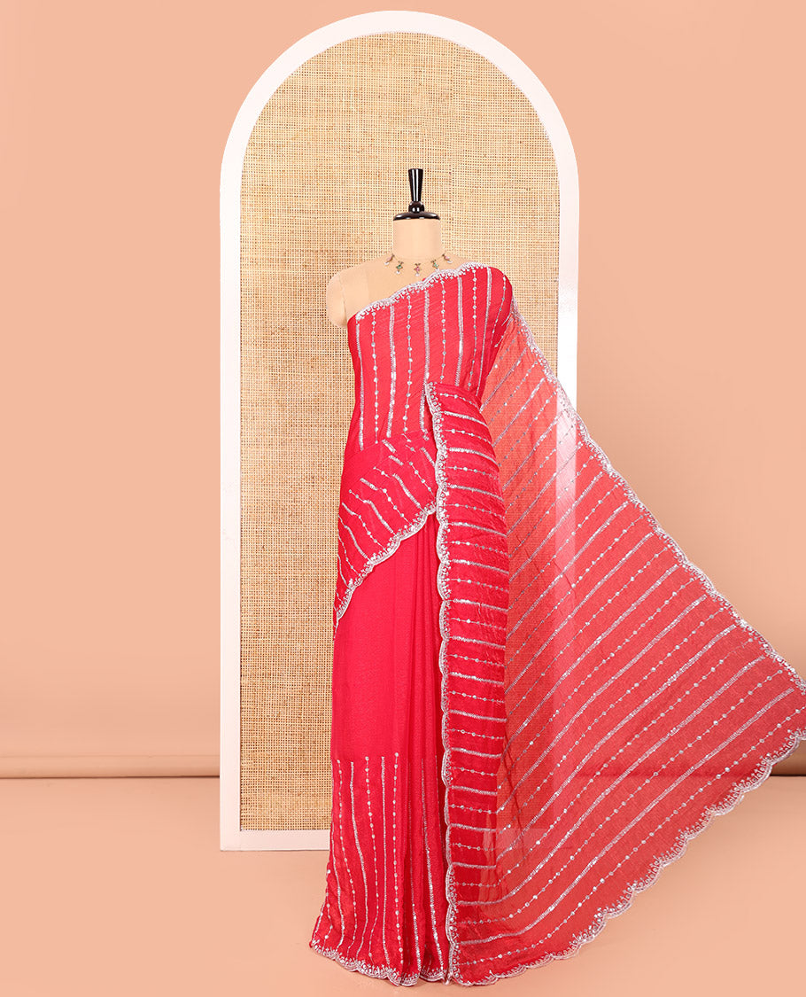 Rani Pink Fendy Chiffon Saree Highlighted with Sequins and Thread Stripes Embroidery, Scallop Embroidered Border, Elegantly Embroidered Pallu, and Paired with a Matching Blouse