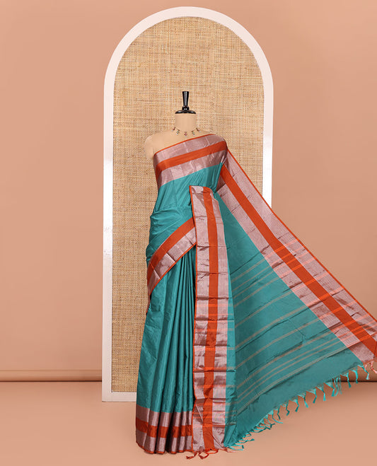 Rama Plain Semi-Soft Silk Saree, Complemented by a Contrast Zari Woven Border, Pallu Features Sparse Stripes, and Paired with a Matching Blouse