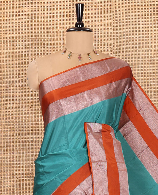 Rama Plain Semi-Soft Silk Saree, Complemented by a Contrast Zari Woven Border, Pallu Features Sparse Stripes, and Paired with a Matching Blouse
