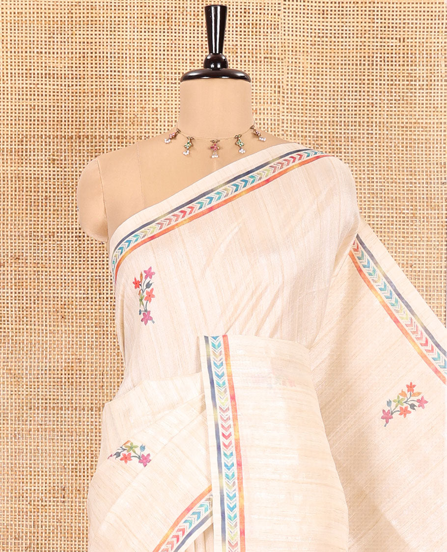 Chikku Semi-Tussar Silk Saree, Embellished with Floral Motifs Printed on Its Body, a Subtle Chevron Striped Border, Pallu Accentuated by Colorful Floral Vine and Bird Print, and Paired with a Matching Printed Blouse