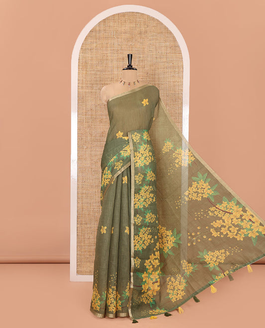 Green Linen Saree, Detailed with Averrhoa Carambola-Style Floral Motifs Print, Subtle Piping Border, Pallu Mirrors the Same Print, and Paired with a Matching Blouse