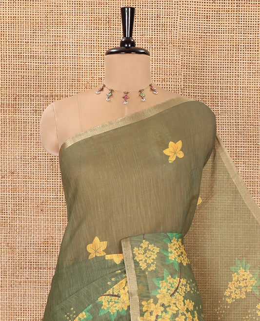 Green Linen Saree, Detailed with Averrhoa Carambola-Style Floral Motifs Print, Subtle Piping Border, Pallu Mirrors the Same Print, and Paired with a Matching Blouse