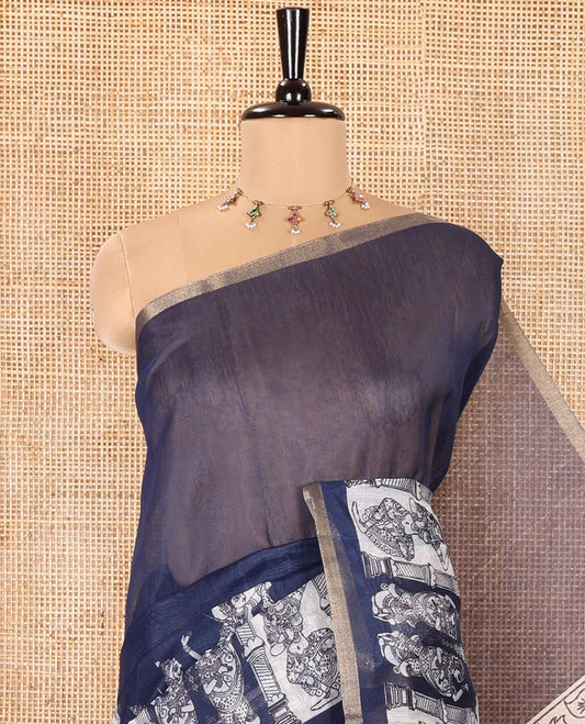 Navy Blue Chanderi Cotton Saree, Elevated with Kalamkari-Style Ancient Human Figurines Printed on Its Body, Subtle Zari Piping Border, Pallu Depicting Kalamkari Peacocks, and Paired with a Matching Blouse