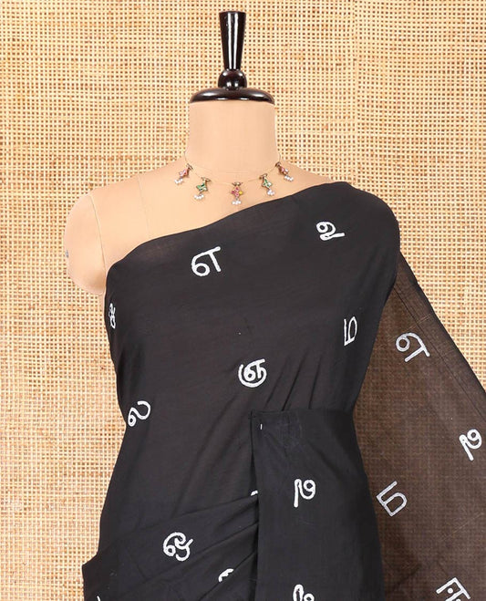 Borderless Black South Cotton Saree, Adorned with Tamil Letters Printed on Its Body, a Self-Pallu, and Comes with a Matching Blouse, and a Contrast Printed Blouse