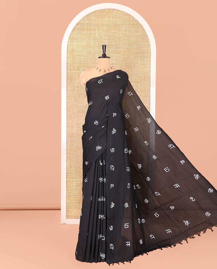 Borderless Black South Cotton Saree, Adorned with Tamil Letters Printed on Its Body, a Self-Pallu, and Comes with a Matching Blouse, and a Contrast Printed Blouse