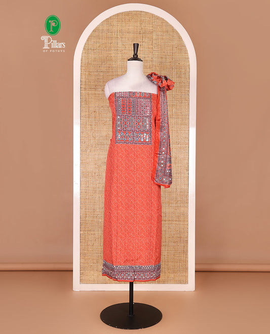 Neon orange material chudidar set, intricately printed with neck mirror work crepe top, Italian crepe bottom, and digital printed mirror work chinon dupatta