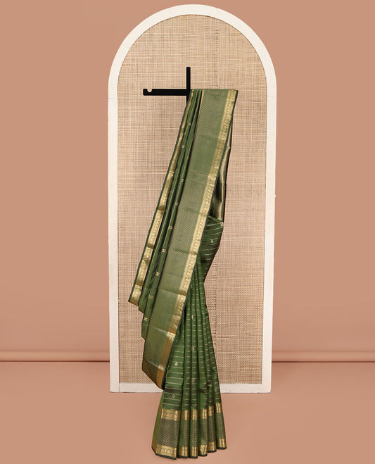 Green Vasundhara Lite Silk Mix Saree, Gleamed Up with Zari Buttas and Stripes, Highlighted by Zari Border of Rekku, Rudraksham, and Jada Nagam Designs, Sparsely Sparkled Pallu, and Paired with a Matching Blouse