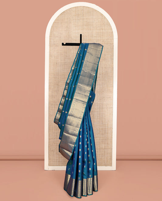 Blue Vasundhara Lite Silk Mix Saree, Graced with Zari Buttas All Over Its Body, Highlighted by a Zari Border of Rekku, Muthu, Kathir, Kodi Visiry, and Jaal Designs, Grand Jaal Pallu, and Paired with a Matching Blouse