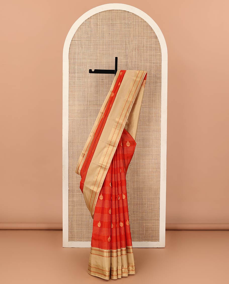Orange zari checks and buttas Vasundhara silk mix saree, contrast rettai pettu border of thilakam mokku, muthu, cross neli, poun, ara madaam, and mayil designs, and then kuli kann pallu