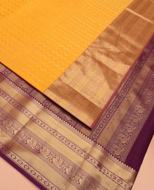 Yellow Vasundhara Lite Silk Mix Saree Highlighted by Zig-Zag Stripes, Featuring a Contrast Border of Rekku, Muthu, Puli Nagam, Laddu Kamalam, and Mayil Designs, Pallu Steeped with Traditional Zari Designs, and a Contrast Blouse