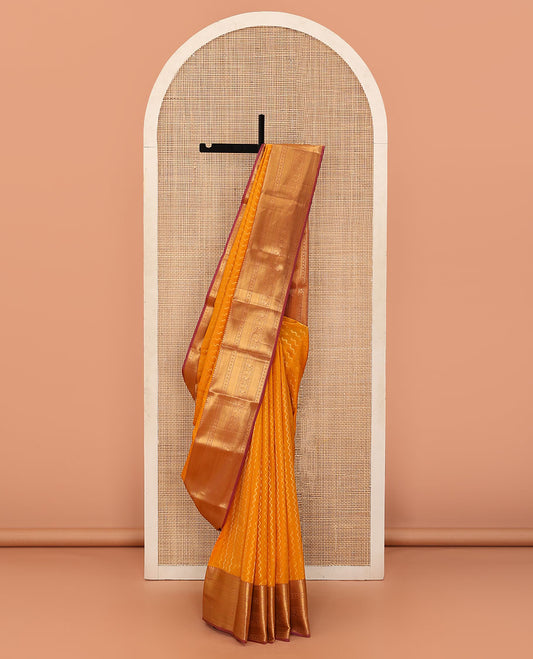 Yellow Vasundhara Lite Silk Mix Saree Highlighted by Zig-Zag Stripes, Featuring a Contrast Border of Rekku, Muthu, Puli Nagam, Laddu Kamalam, and Mayil Designs, Pallu Steeped with Traditional Zari Designs, and a Contrast Blouse