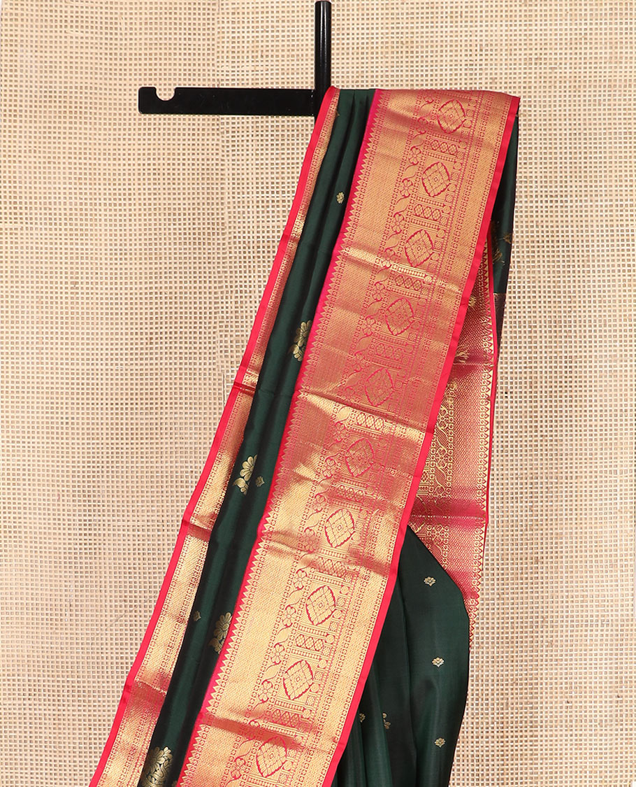 Green Vasundhara Silk Saree Decorated with Zari Buttas, Complemented by a Contrast Border of Rekku, Mayil Kann, Cross Kamalam, Laddu Kamalam, Rudraksham, Rettai Neli, Muthu, and Mayil Kann, Grandly Woven Jaal Pallu, and Paired with a Contrast Blouse