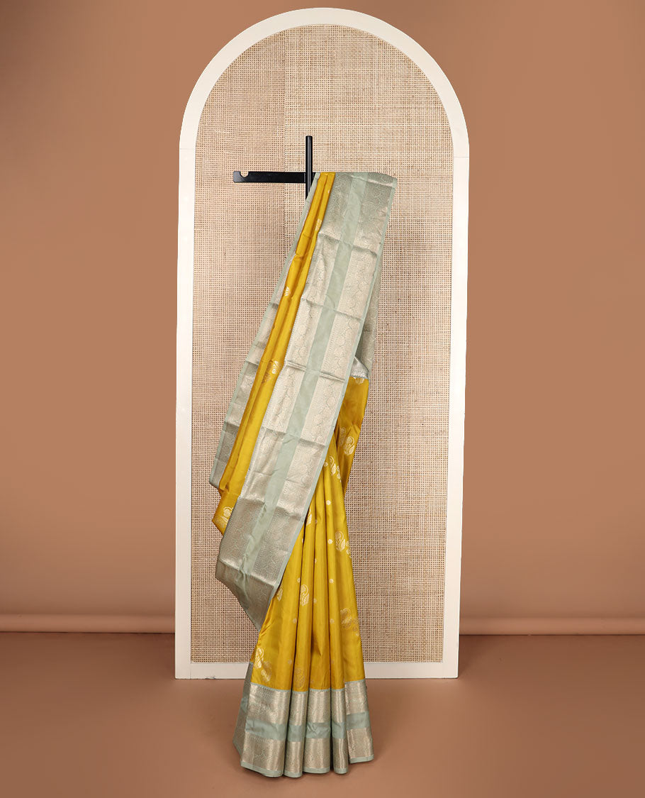 Yellow zari buttas silk saree, contrast rettai pettu border of thilakam,manga,banaras,poun & kodi visiry & floral design pallu
