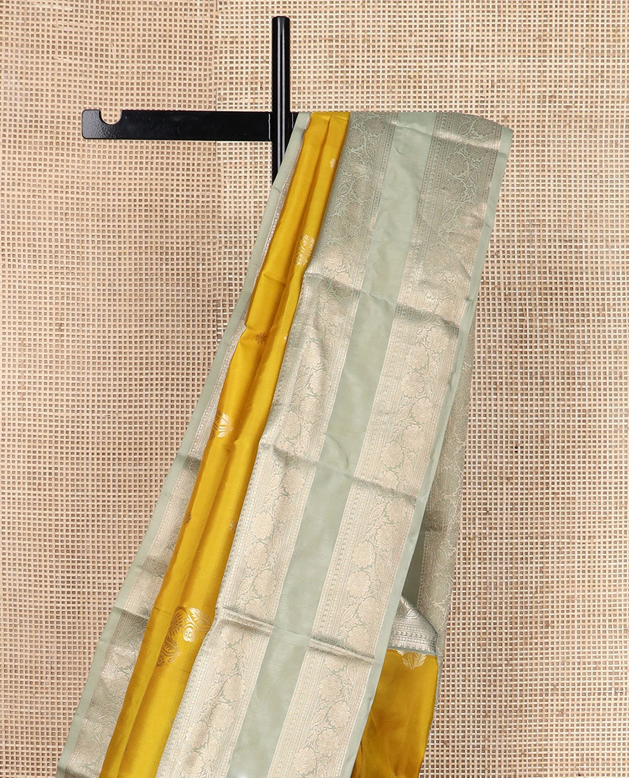 Yellow zari buttas silk saree, contrast rettai pettu border of thilakam,manga,banaras,poun & kodi visiry & floral design pallu