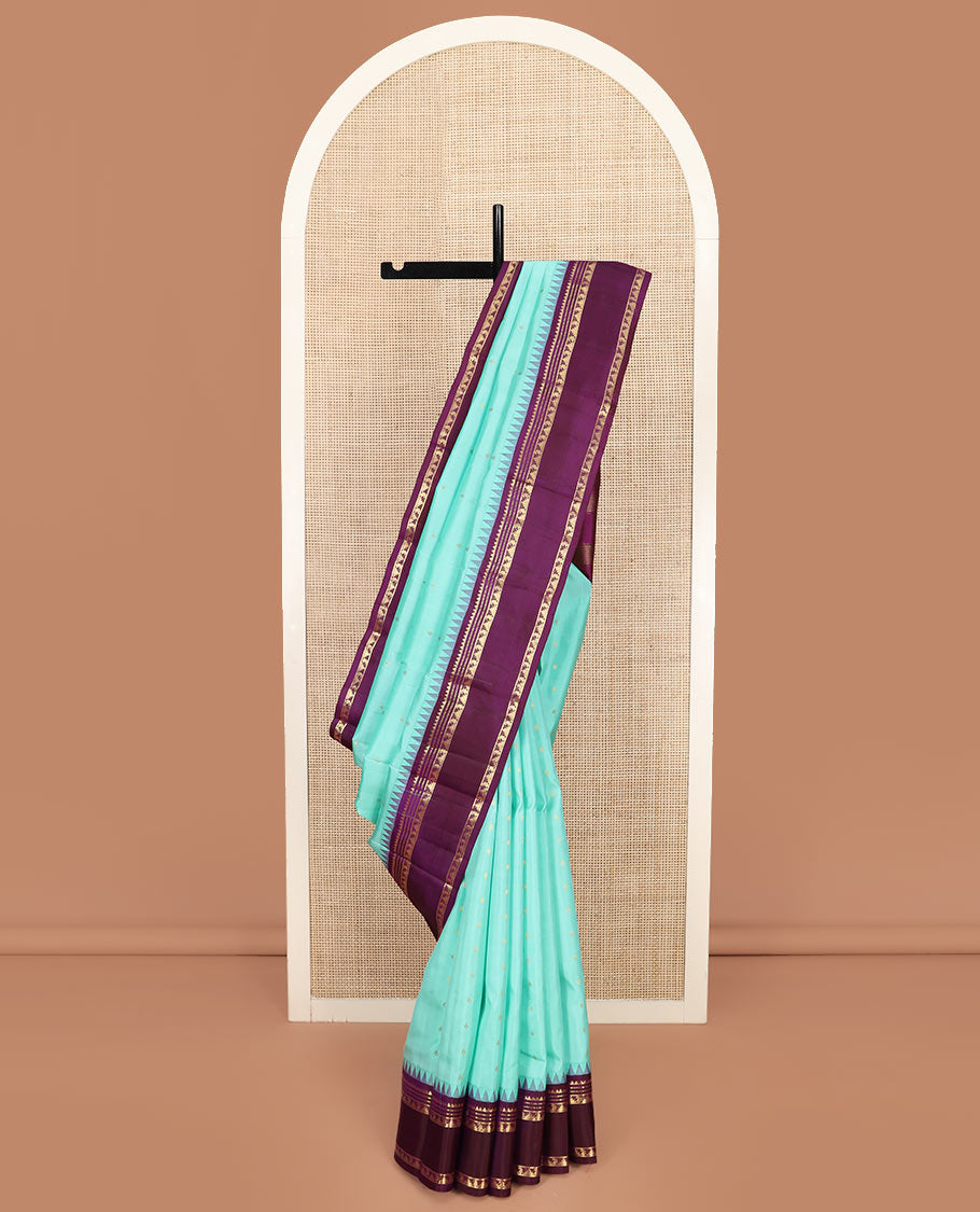 Blue Vasundhara Silk Saree Mesmerized with Zari Buttas, Complemented by a Contrast  Border of Thazampoo Rekku, Muthu, and Manga Designs, Subtly Sparkled Zari Woven Pallu, and a Contrast Blouse