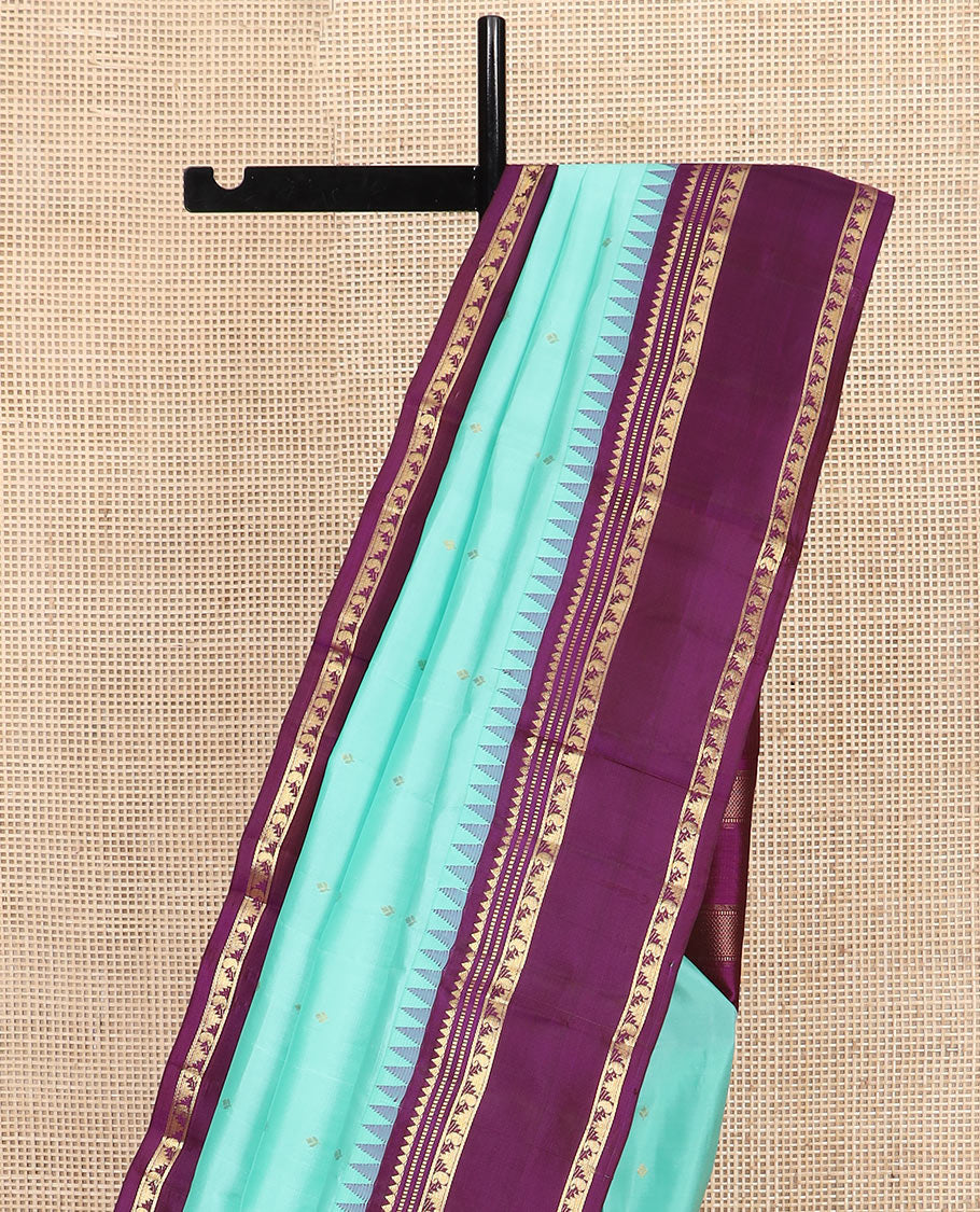 Blue Vasundhara Silk Saree Mesmerized with Zari Buttas, Complemented by a Contrast  Border of Thazampoo Rekku, Muthu, and Manga Designs, Subtly Sparkled Zari Woven Pallu, and a Contrast Blouse