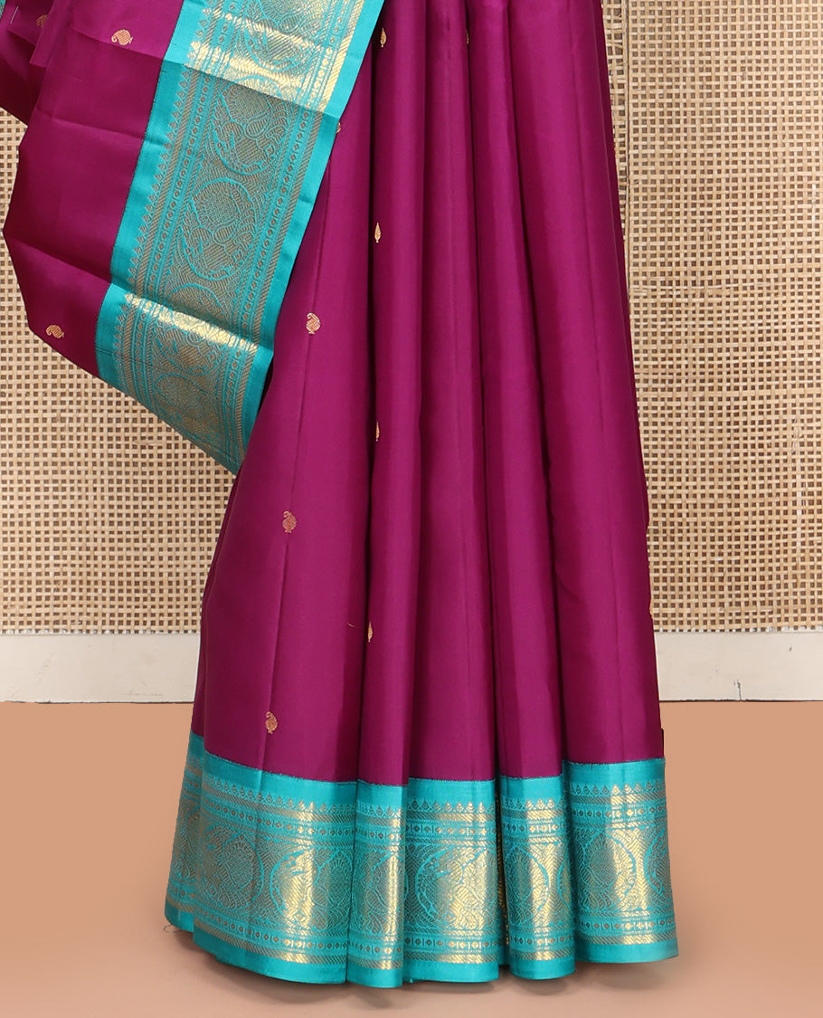 Purple Vasundhara Silk Saree, Subtly Sparkled With Zari Buttas All Over Its Body, Complemented by Zari Buttas All Over Its Body, Complemented by Contrast Border of Thilakam, Banaras, and Mayil Designs Grand Jaal Pallu and Paired with a Contrast Blouse