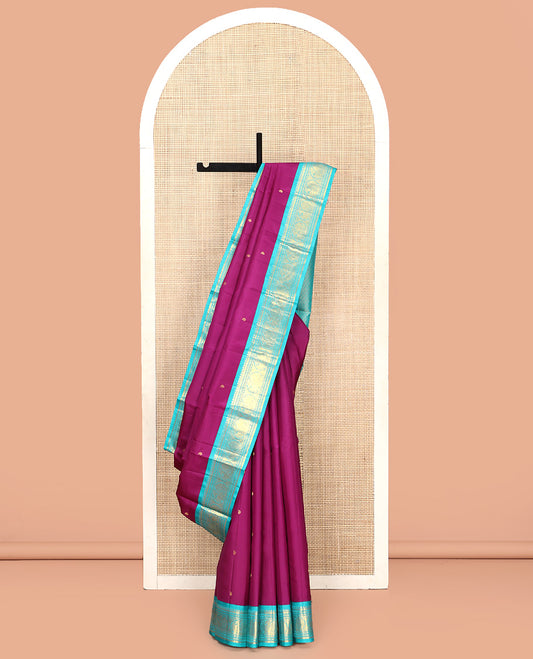 Purple Vasundhara Silk Saree, Subtly Sparkled With Zari Buttas All Over Its Body, Complemented by Zari Buttas All Over Its Body, Complemented by Contrast Border of Thilakam, Banaras, and Mayil Designs Grand Jaal Pallu and Paired with a Contrast Blouse