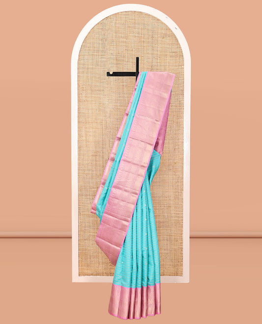 Blue Vasundhara Silk Saree, Sparsely Sparkled with Zari Stripes and Buttas, Contrast Border of Muthu, Kamalam, Mayil, Poun, Ara Maadam, and Mayil Designs, Grand Pallu, and a Contrast Blouse