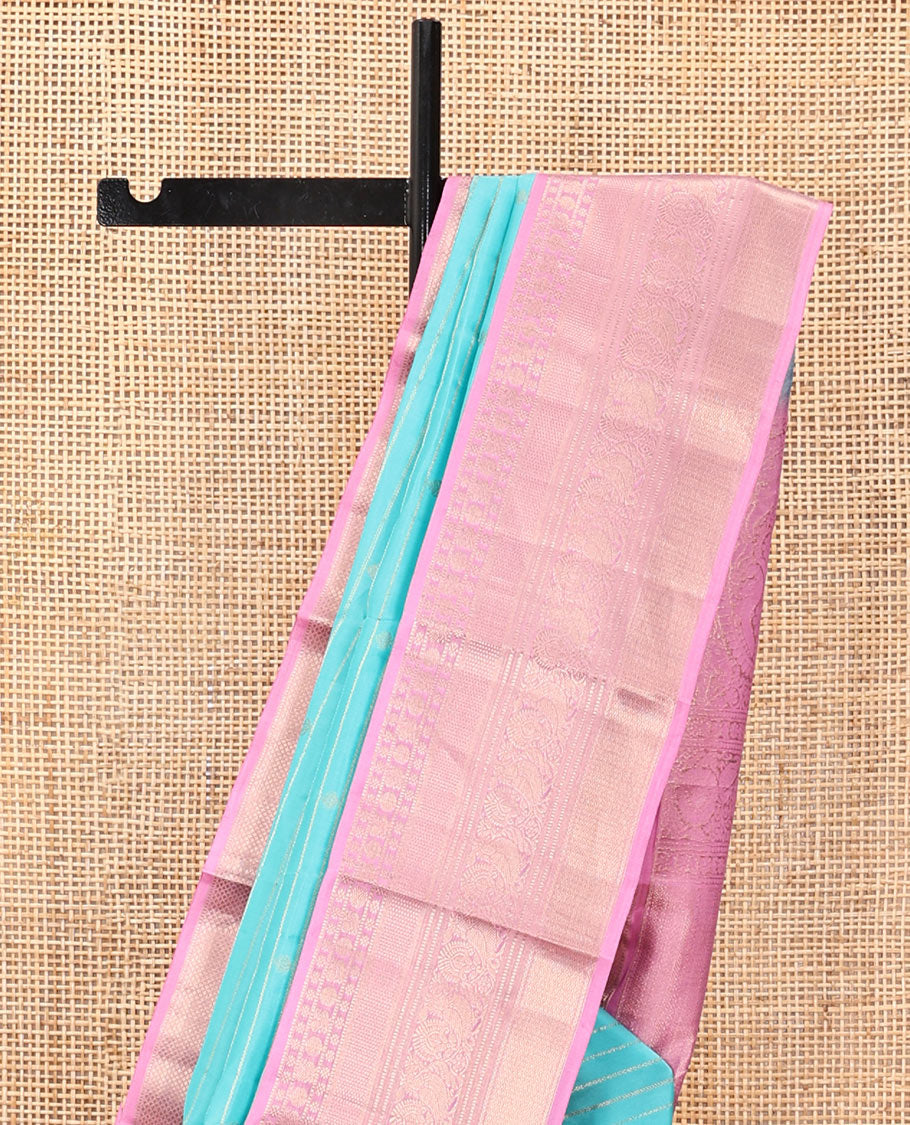 Blue Vasundhara Silk Saree, Sparsely Sparkled with Zari Stripes and Buttas, Contrast Border of Muthu, Kamalam, Mayil, Poun, Ara Maadam, and Mayil Designs, Grand Pallu, and a Contrast Blouse