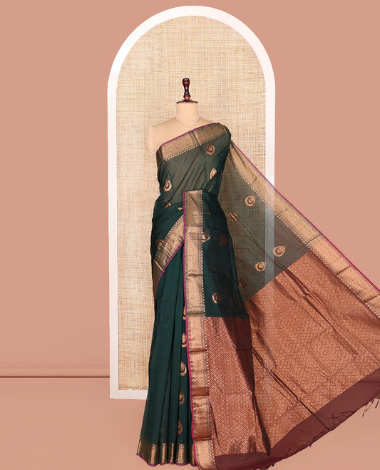 Green Semi-Silk Cotton Saree, Enthralled with Drop-Shaped Zari Buttas on Its Body, Complemented by Contrast Traditional Zari Border, Grand Pallu of Jaal Designs, and Paired with a Contrast Blouse