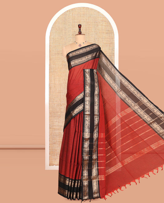 Brick Red Plain Chettinad Cotton Saree, Complemented by a Contrast Yaali-Chakram Zari Border, Striped Pallu, and a Matching Blouse