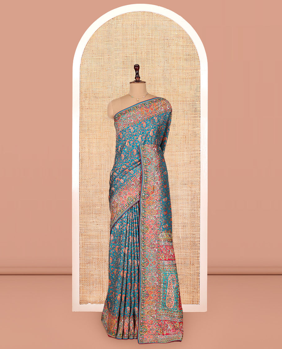 Blue Dola Silk Saree, Opulently Embellished with Colorful Floral-Paisley Design on Its Body, Highlighted by Print and Embroidery Border, Colorfully Decked Up Pallu, and Paired with a Contrast Blouse
