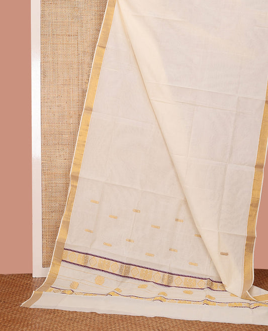 Cream Kerala Saree, Subtly Enriched with Zari Buttas on Its Body, Bavanji Zari Border, Sparkling Pallu of Zari Designs, and Paired with a Matching Blouse