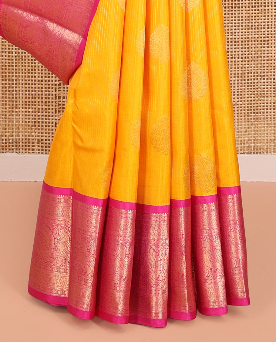 Yellow Vasundhara Silk Saree, Detailed with Zari Buttas and Stripes All Over Its Body, Complemented by a Contrast Border of Rekku, Muthu, Poun, Chakram, and Mayil Designs, Grand Manga Design Pallu, and Paired with a Contrast Blouse