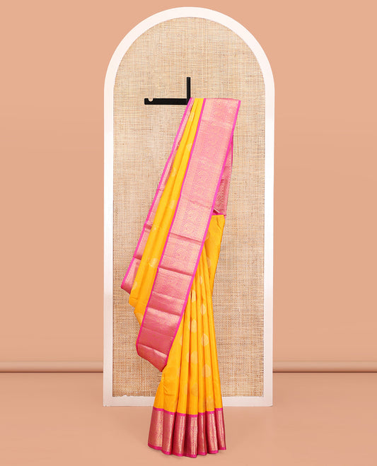 Yellow Vasundhara Silk Saree, Detailed with Zari Buttas and Stripes All Over Its Body, Complemented by a Contrast Border of Rekku, Muthu, Poun, Chakram, and Mayil Designs, Grand Manga Design Pallu, and Paired with a Contrast Blouse