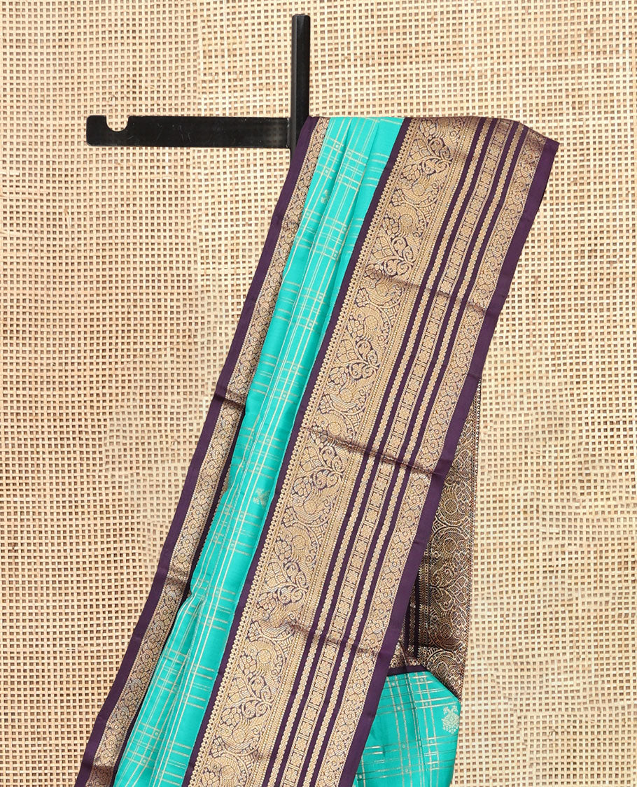 Turquoise Vasundhara Silk Saree, Accentuated with Zari Checks, a Contrast Border of Thilakam Mokku, Mayil, Neli, and Kamalam Designs, a Grand Jaal Pallu, and a Contrast Blouse