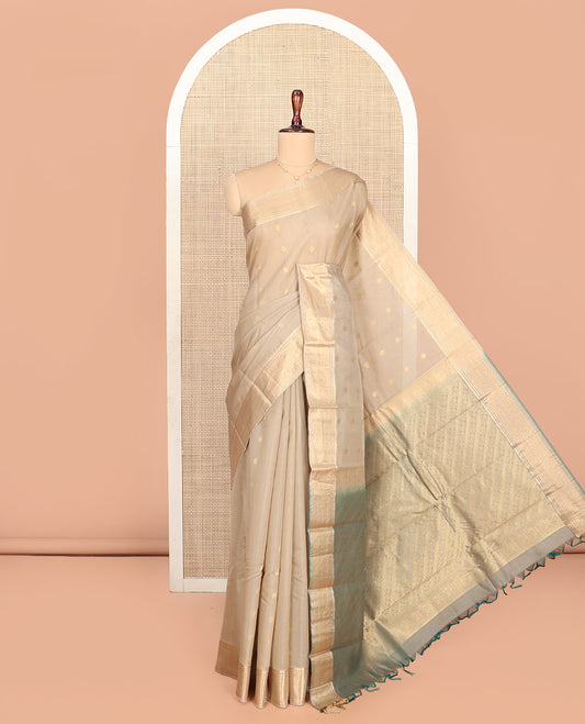 Beige Silk Cotton Saree, Gleamed up with Zari Buttas All Over Its Body, Highlighted by Traditional Zari Designs Woven Border, Diagonally Woven Pallu and Paired with a Contrast Blouse