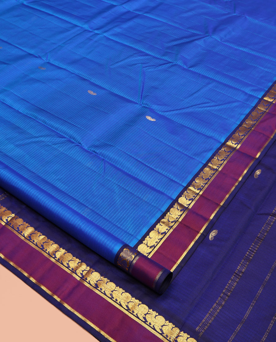Blue Kanchipuram Silk Saree, Sparsely Sparkled with Vazhaipoo Stripes and Zari Buttas on Its Body, Complemented by Contrast Rettai Pettu Border of Mayil, and Kathir Designs, Zari-Striped Pallu, and Paired with a Contrast Blouse