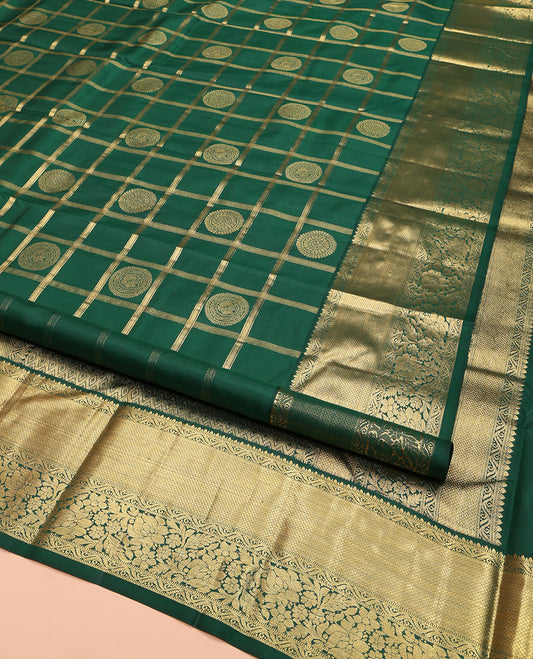Green Kanchipuram Silk Saree, Majestically Detailed with Chakram Butta Enclosed Checks on Its Body, Highlighted by Zari Border of Muthu, Mayil Kann, and Kodi Visiry Designs, Grand Jaal Pallu, and Paired with a Matching Blouse