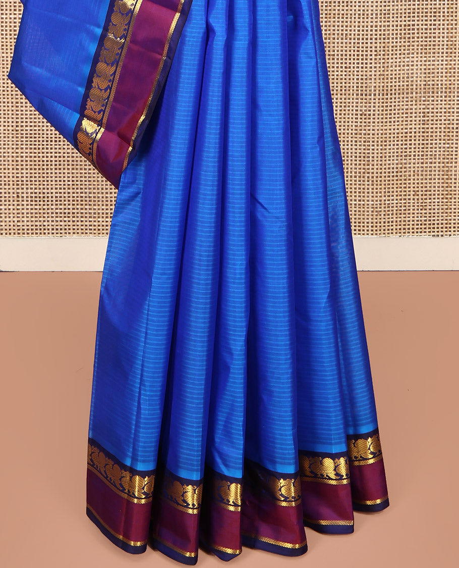Blue Kanchipuram Silk Saree, Sparsely Sparkled with Vazhaipoo Stripes and Zari Buttas on Its Body, Complemented by Contrast Rettai Pettu Border of Mayil, and Kathir Designs, Zari-Striped Pallu, and Paired with a Contrast Blouse