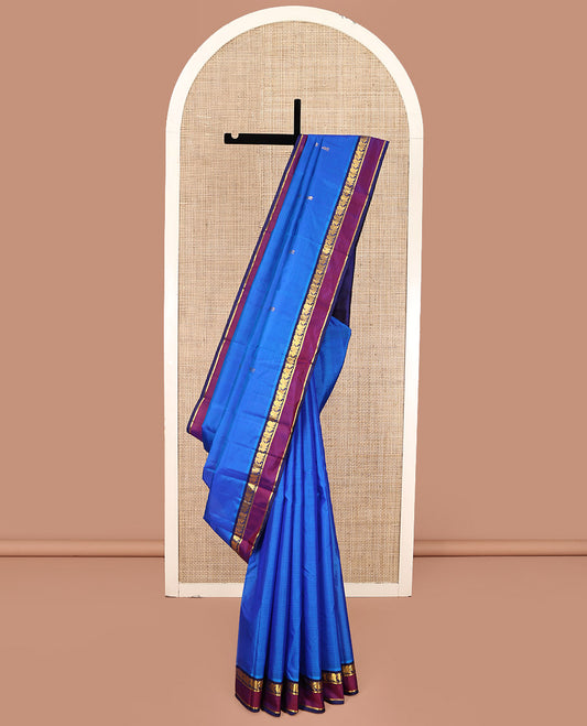 Blue Kanchipuram Silk Saree, Sparsely Sparkled with Vazhaipoo Stripes and Zari Buttas on Its Body, Complemented by Contrast Rettai Pettu Border of Mayil, and Kathir Designs, Zari-Striped Pallu, and Paired with a Contrast Blouse