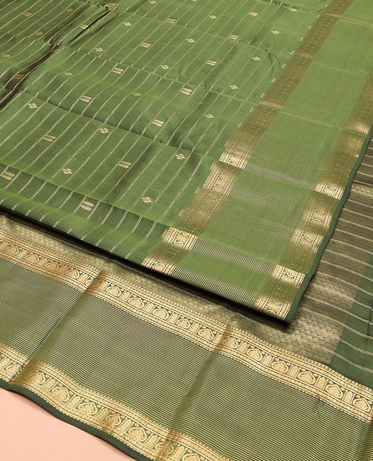 Green Vasundhara Lite Silk Mix Saree, Gleamed Up with Zari Buttas and Stripes, Highlighted by Zari Border of Rekku, Rudraksham, and Jada Nagam Designs, Sparsely Sparkled Pallu, and Paired with a Matching Blouse