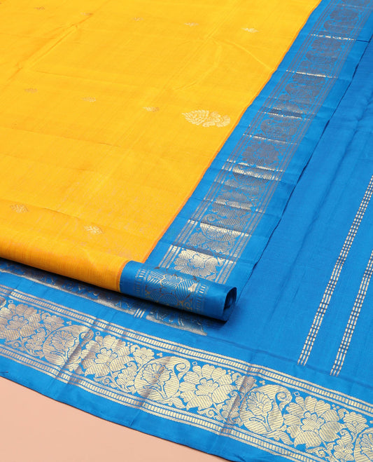 Yellow Kanchipuram Silk Saree, Ornamented with Zari Buttas on Its Body, Complemented by a Contrast One-Sided Korvai Border of Banaras, Muthu, Floral and Paisley Designs, Pallu of Intricate Designs, and Comes Without a Blouse