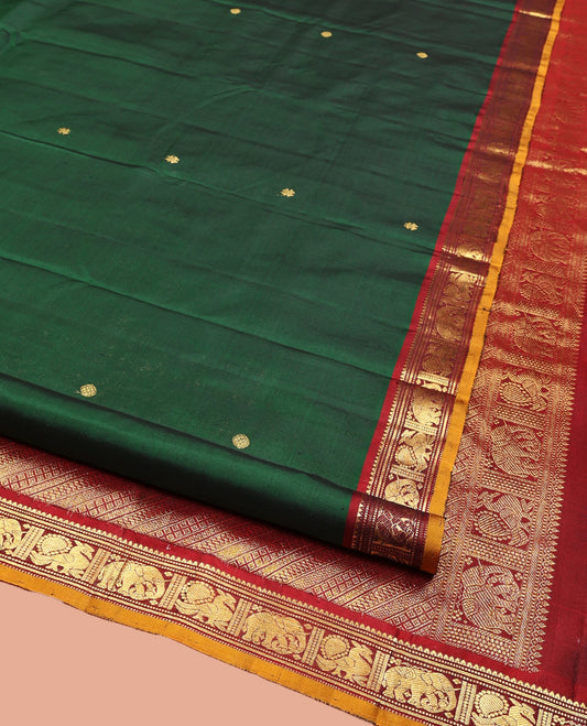 Green Kanchipuram Silk Saree, Elevated with Zari Buttas All Over Its Body, Complemented by Contrast  Border of Rekku, Muthu, Banaras, Yaanai, and Mayil Designs, Pallu Steeped with Geometric Designs, and Paired with a Contrast Blouse