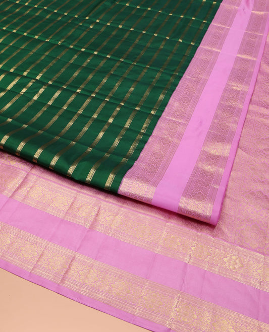 Green Vasundhara Silk Saree, Gracefully Embellished with Zari Stripes All Over Its Body, Complemented by Contrast Rettai Pettu Traditional Zari Design Border, Intricately Designed Pallu, and Paired with a Contrast Blouse