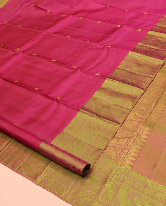 Red Kanchipuram Designer Silk Saree, Subtly Sparkled With Buttas All Over Its Body, Complemented by Contrast Border of Rekku, Rudraksham, Then Kuli Kann, Laddu Kamalam, and Mayil Kann Designs, Jaal Pallu and Paired with a Contrast Blouse
