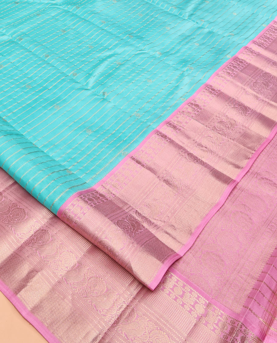 Blue Vasundhara Silk Saree, Sparsely Sparkled with Zari Stripes and Buttas, Contrast Border of Muthu, Kamalam, Mayil, Poun, Ara Maadam, and Mayil Designs, Grand Pallu, and a Contrast Blouse