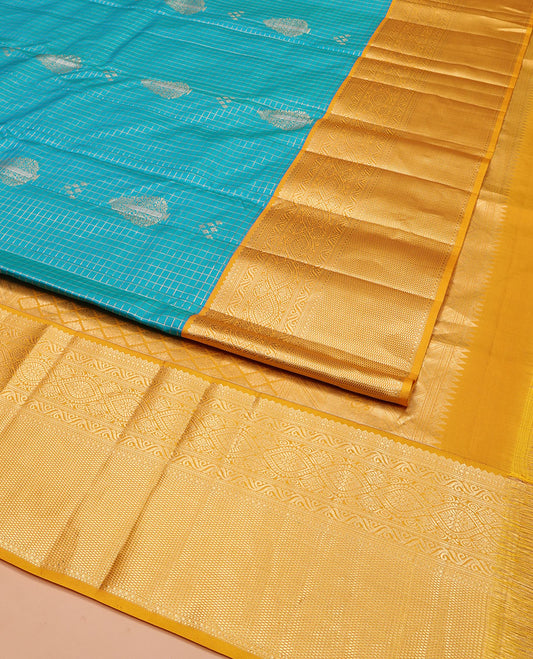 Blue Vasundhara Silk Saree, Masterfully Woven with Zari Buttas and Zari Checks All Over Its Body, Complemented by a Contrast Border of Traditional Designs, Grandly Woven Jaal Pallu, and Paired with a Contrast Blouse