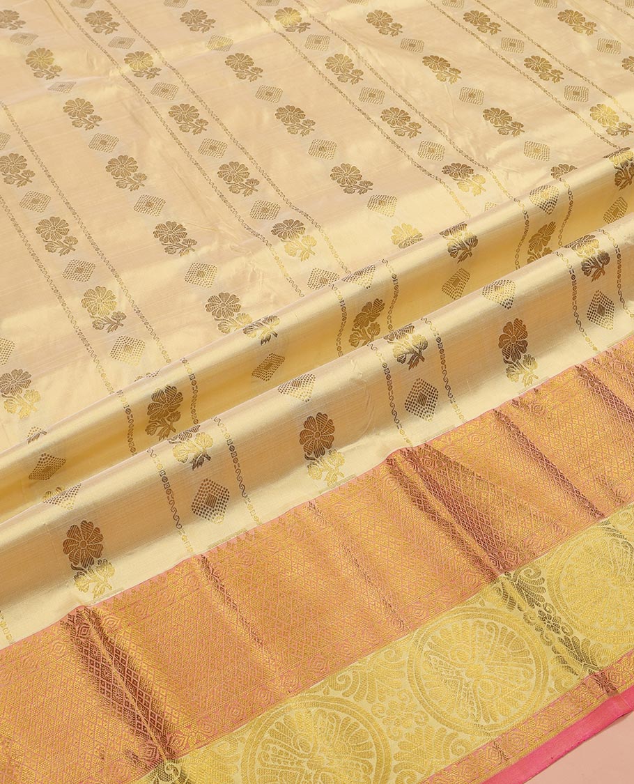 Gold Pure Silk Half-Saree, Spotlighted with Zari Buttas All Over Its Skirt, Complemented by Contrast Border of Jaal and Chakram Designs, Paired with a Contrast Blouse, and Comes with a Floral Design Dhavani