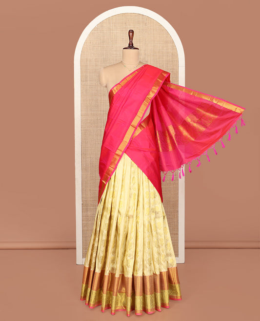 Gold Pure Silk Half-Saree, Spotlighted with Zari Buttas All Over Its Skirt, Complemented by Contrast Border of Jaal and Chakram Designs, Paired with a Contrast Blouse, and Comes with a Floral Design Dhavani