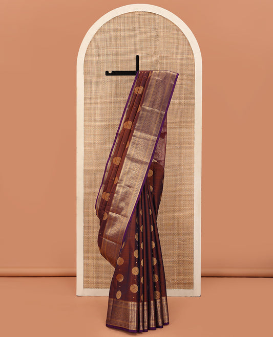 Brown Vasundhara Lite Silk Mix Saree Beautified with Chakram Zari Buttas, Complemented with a Contrast Border Featuring Rekku, Muthu, Kathir, Kamalam, and Mayil Designs, Pallu Elevated with Jaal Designs, and Paired with a Contrast Blouse