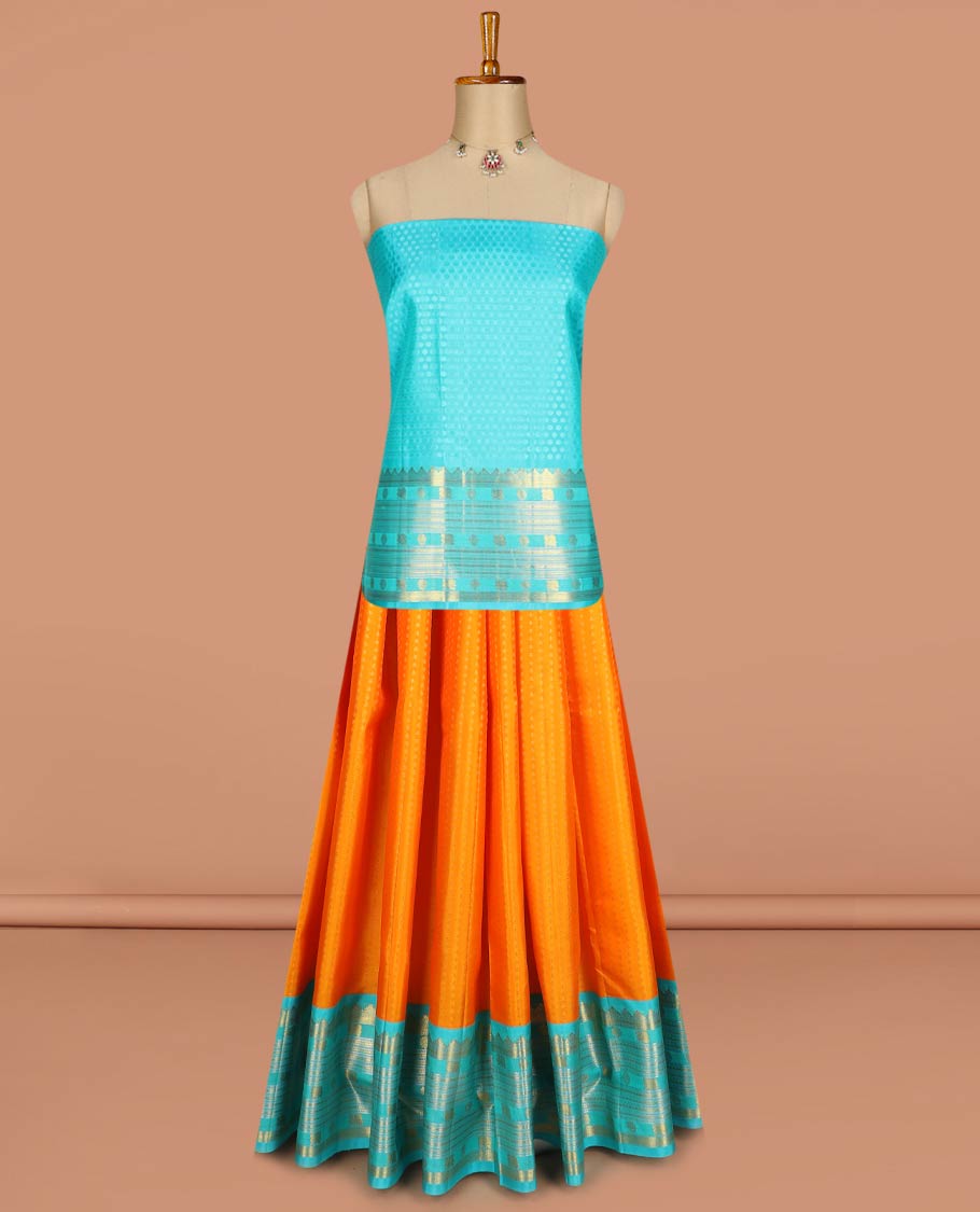 Orange pure-silk half-saree, buttas with a contrast mayil chakram bordered skirt, contrast blouse, and a leaf jaal dhavani